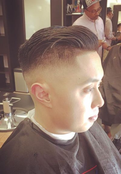 Combed back hair with high fade for asian guys