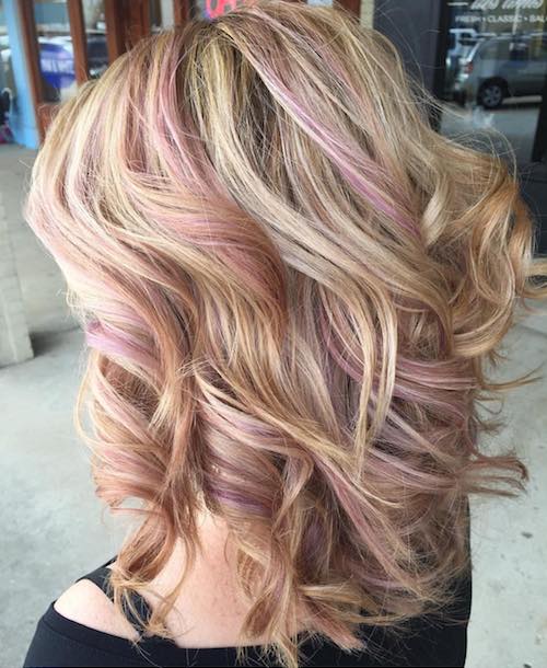 curly blonde with baby pink hair coloer