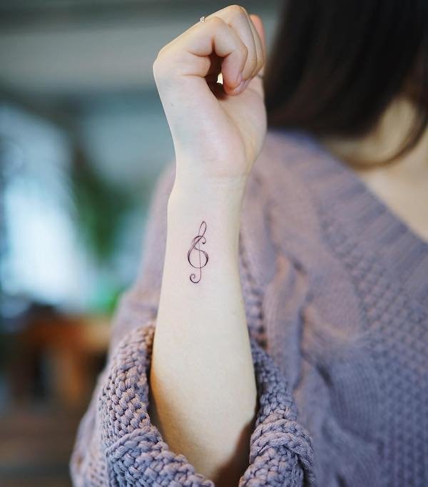 treble clef wrist tattoo